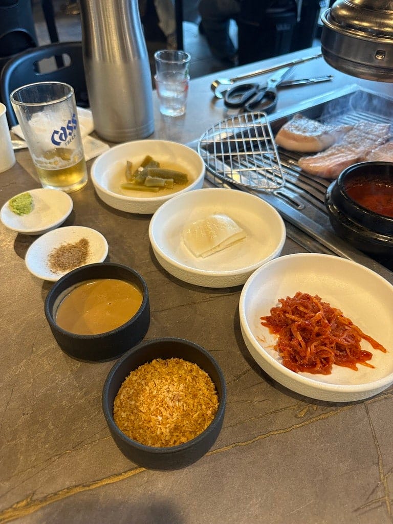 Side dishes at Godokan, including a bowl of bread crumbs served as a dip for the pork