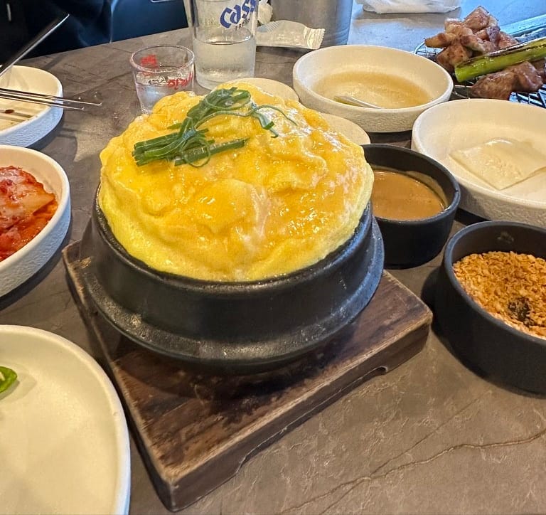 A tall, fluffy steamed egg (gyeranjjim) in a stone pot at Godokan