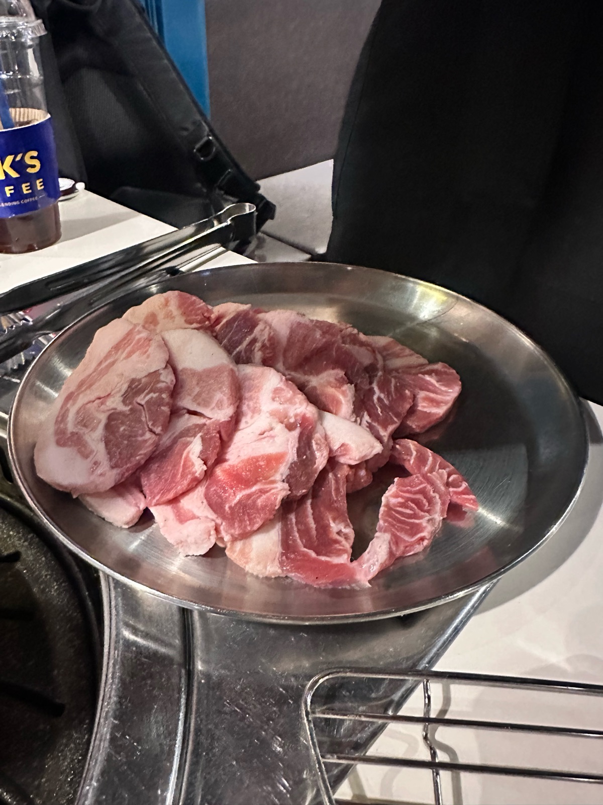 A plate of raw aged Jeju jjolgitsal, thick slices of pork, at Gojip132 in Seongsu