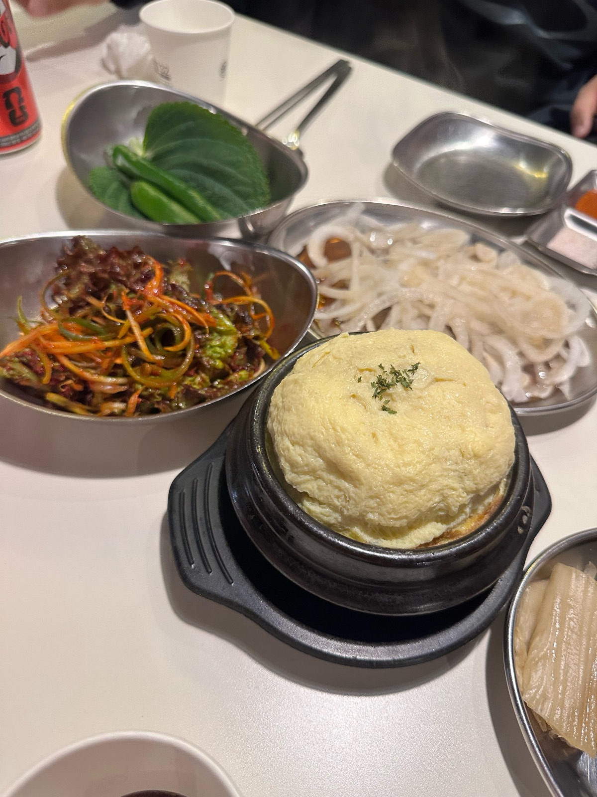 Bomb steamed egg puffed high above its earthenware pot, with side dishes, at Gojip132