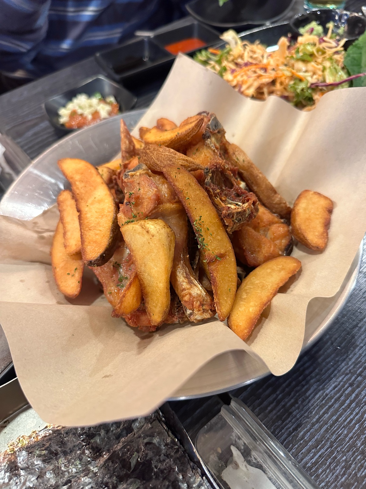 A basket of Singsing fried chicken with potato wedges at Singsingi Yachae Makhoe